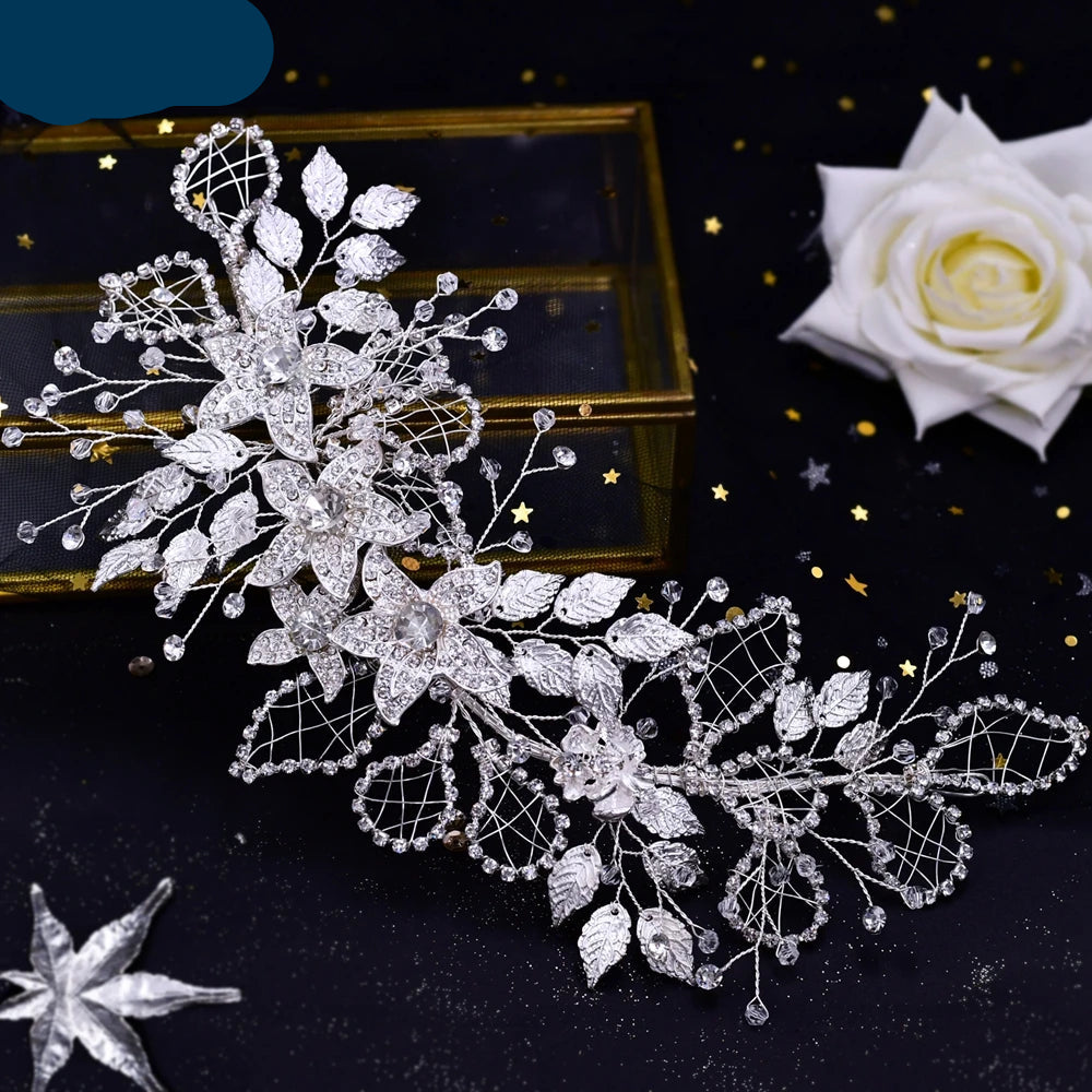 Floral bridal hairpiece with silver leaves and sparkling rhinestones displayed elegantly