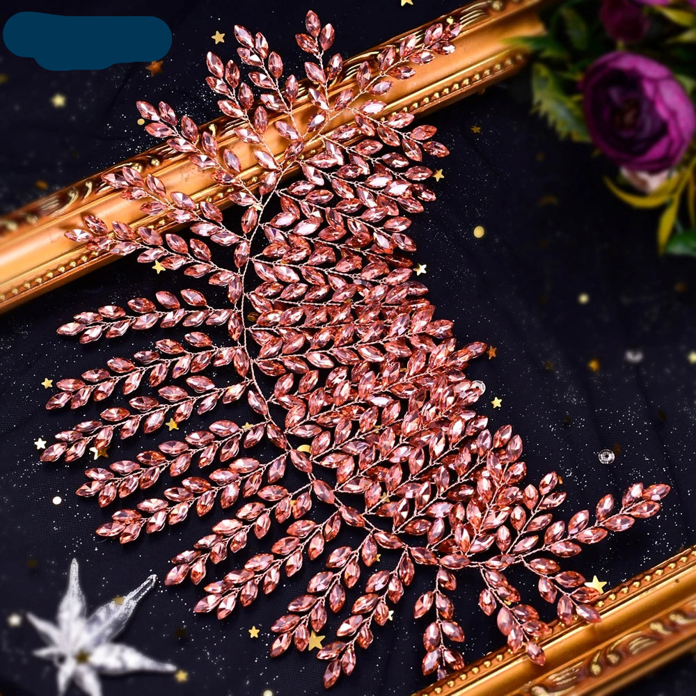 Pink crystal bridal hair vine with delicate leaf motifs on a gold frame