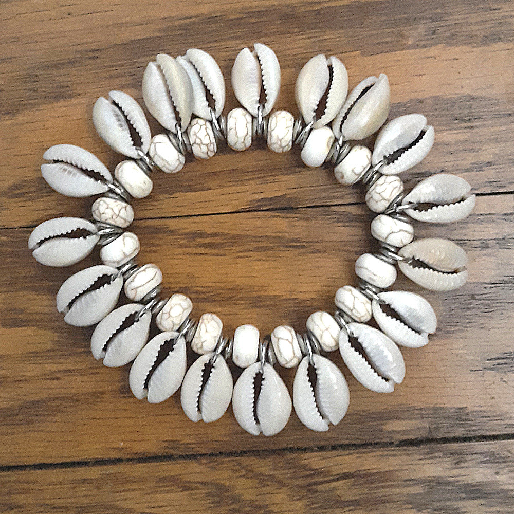 Cowrie shell bracelet with white and brown shell details. A beautiful and versatile accessory for natural hair and loc styles.