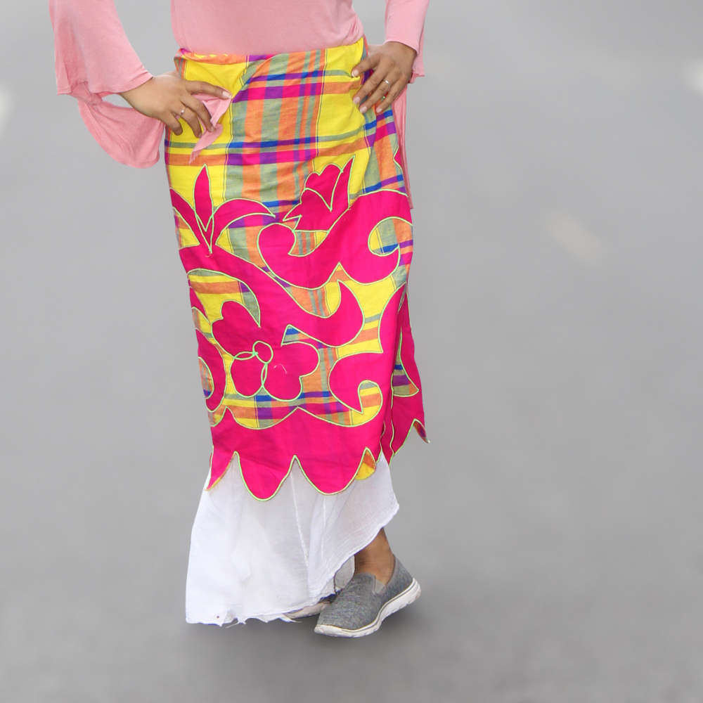 Close-up of a woman wearing the Majestic Maroon Pangi Wrap as a skirt, highlighting its bold colors and intricate design.