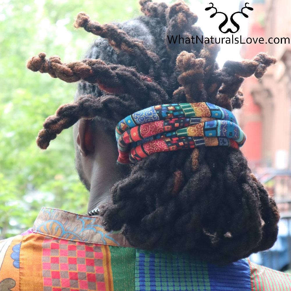 Moldable hair tie holding thick locs in a secure updo. Designed for dreadlocks, braids, and Sisterlocks, offering a comfortable and stylish fit.