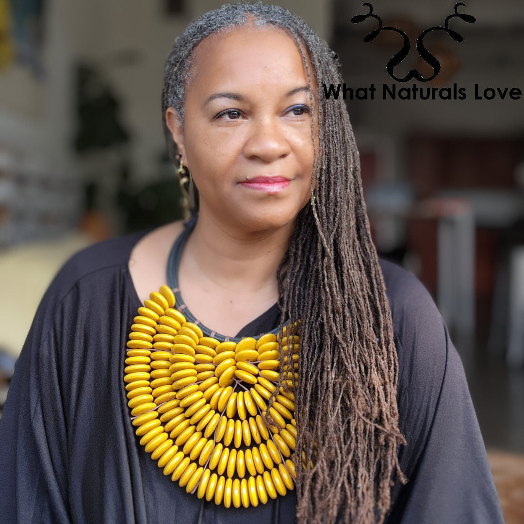 Close-up of a model wearing the Handmade Citrine Cascade Collar, a striking African necklace with yellow wooden beads. A perfect statement jewelry piece.