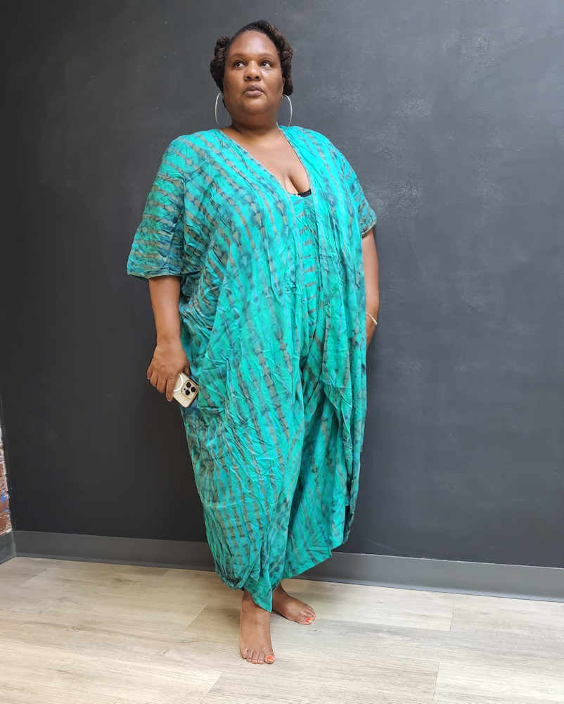 Front view of a plus-size kimono jumpsuit in green tie-dye, with a relaxed fit and draped silhouette. Perfect for effortless style and comfort.