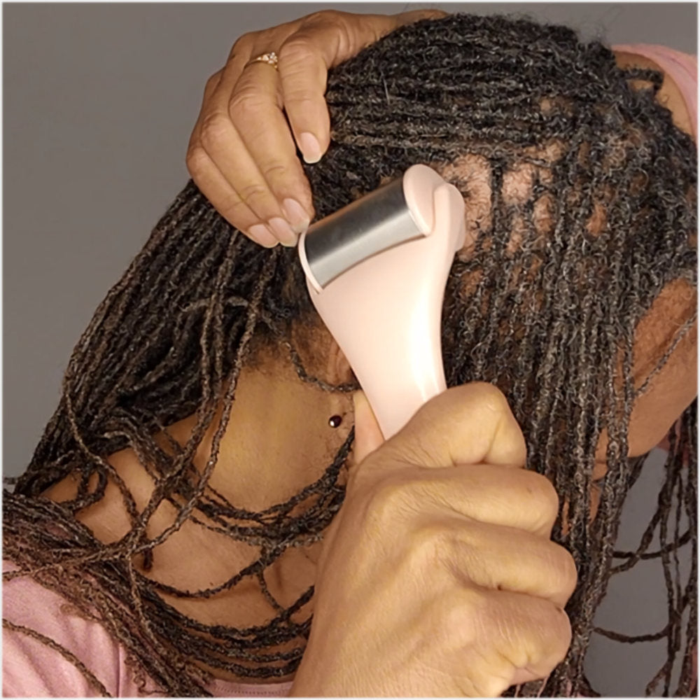 Woman with long locs using a cryotherapy scalp roller to soothe and revitalize her scalp, helping with dryness and itchiness.