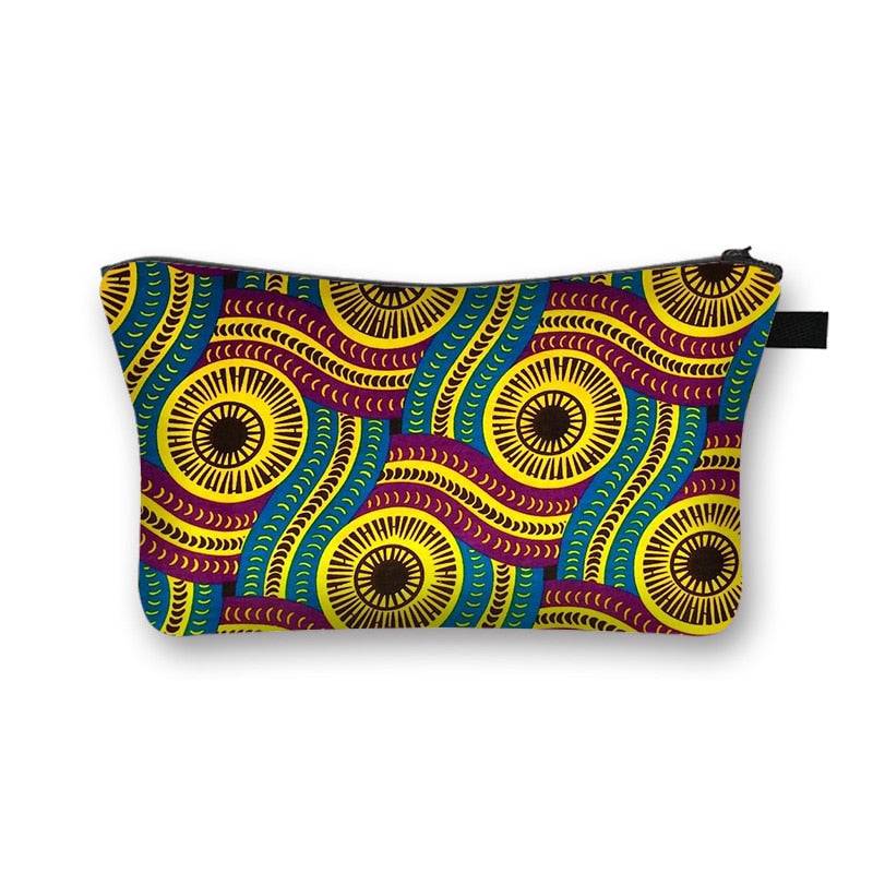 Colorful makeup bag in African print with intricate yellow, blue, and maroon patterns. Stylish and spacious cosmetic pouch with lining.