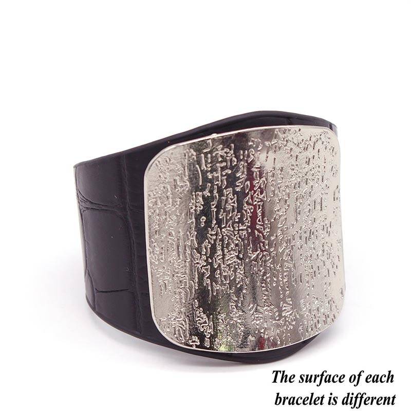 Black leather hair cuff with a textured silver plate, featuring a unique pattern. A bold and elegant hair accessory for locs, sisterlocks, and dreadlocks.