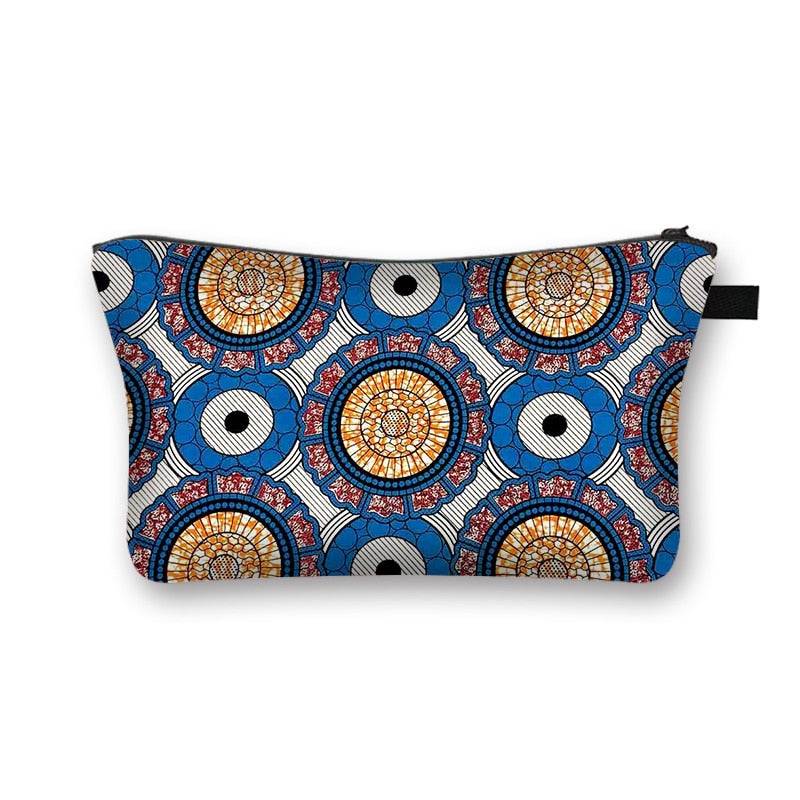 Blue African print makeup bag with intricate circular designs. Durable and lined cosmetic pouch for travel and daily use.
