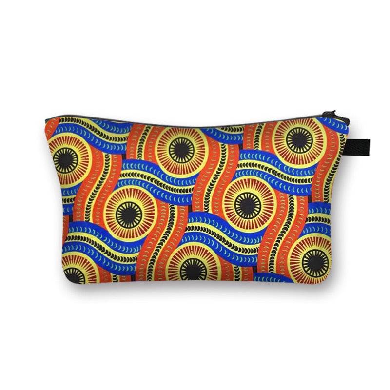 Vibrant African print makeup bag with blue, orange, and yellow swirling patterns. Spacious and lined for beauty essentials.
