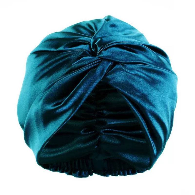 Silk Bonnet Amara De Luxe in teal, featuring a twisted front design. Made from 100% Mulberry Silk for hair protection and style.