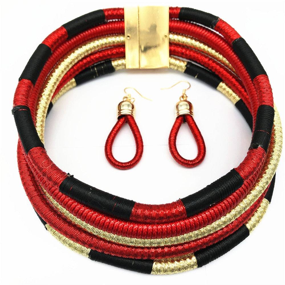 African choker multi-layer necklace set in red, black, and gold with matching teardrop earrings. A striking jewelry set for statement looks.