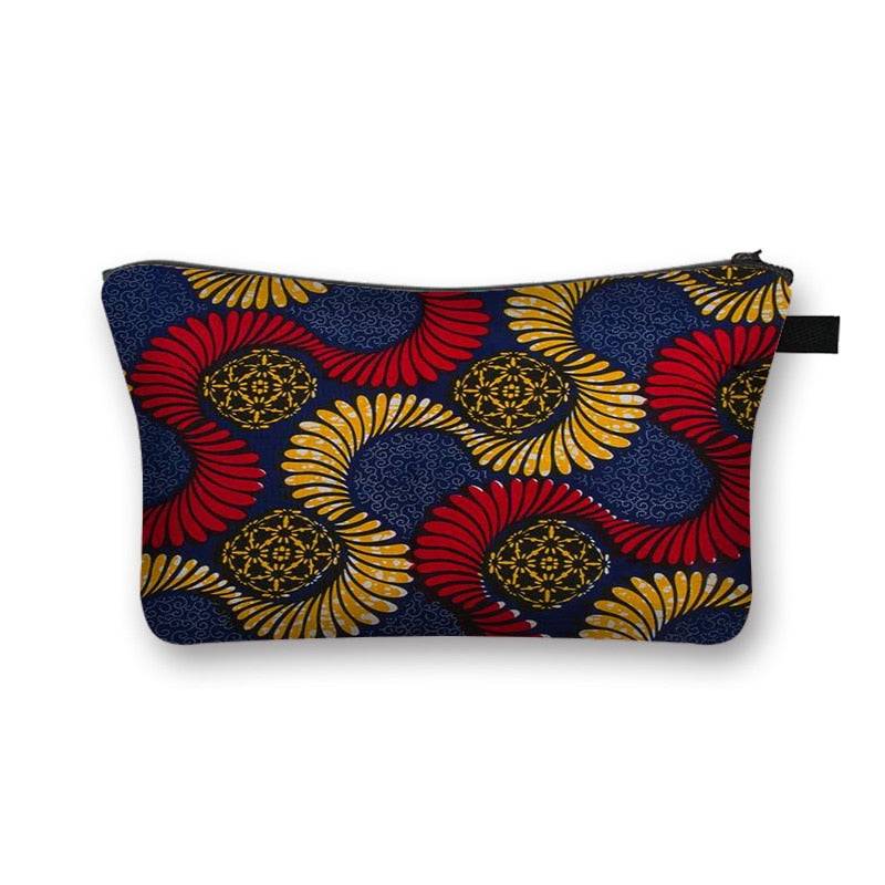 Stylish African print makeup bag with blue, red, and gold circular patterns. Spacious and lined for organizing beauty essentials.