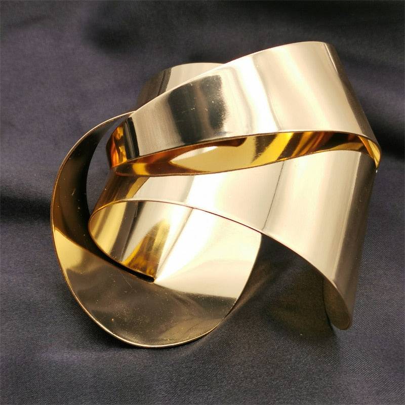 Shiny gold plated hair cuff featuring a sculptural twisted shape, ideal for enhancing locs, sisterlocks, braidlocs, dreadlocks, and braids with a gothic touch.