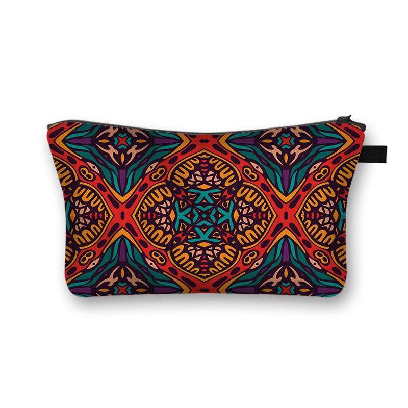 African print makeup bag with intricate red, blue, and orange tribal patterns. Stylish and lined cosmetic pouch for beauty essentials.