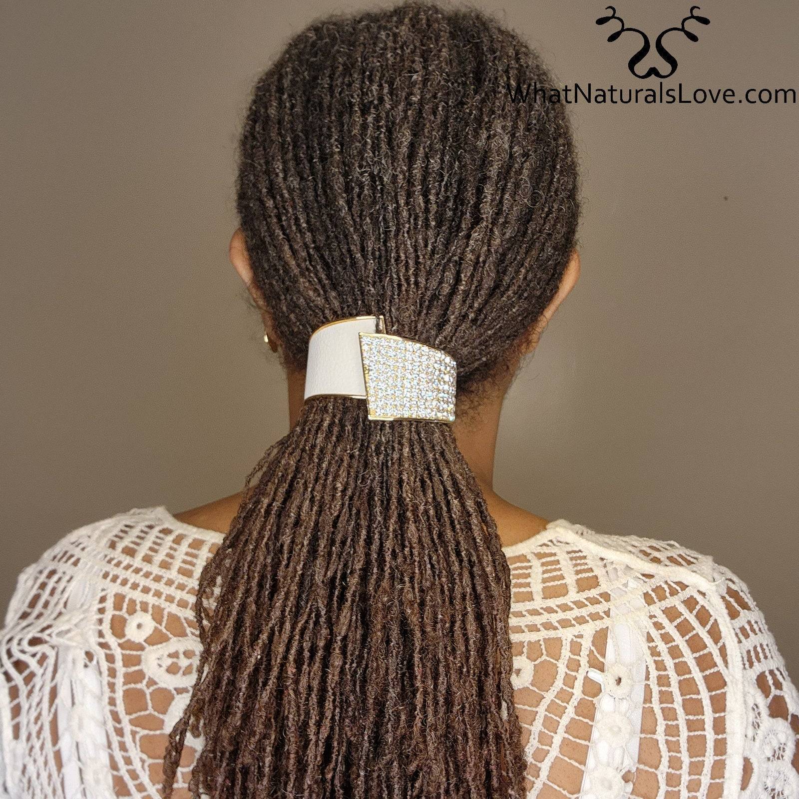 Woman wearing a rhinestone hair cuff securing her locs in a ponytail. A chic and non-damaging accessory for dreadlocks, braids, and curls.