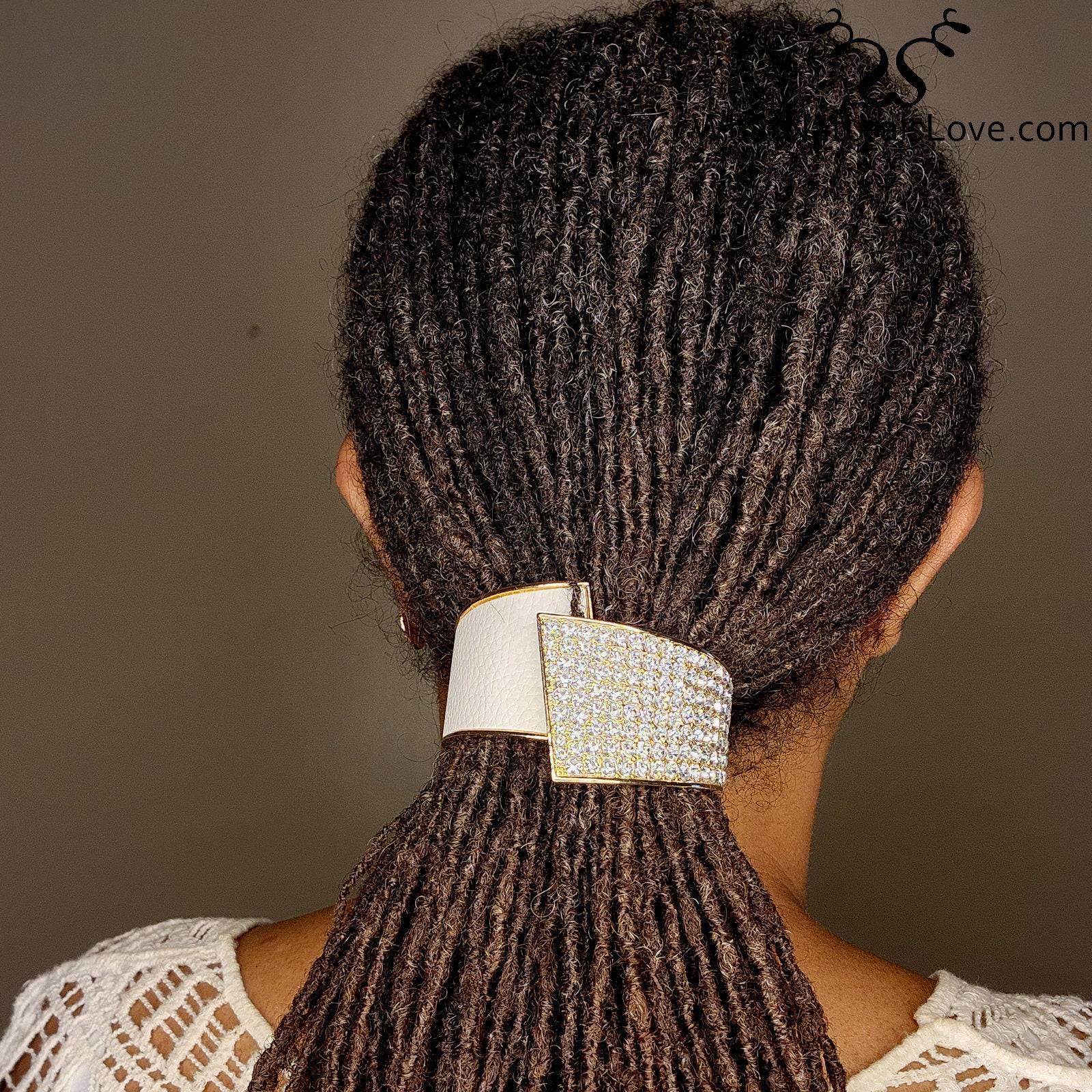 Back view of a woman wearing a rhinestone hair cuff securing her locs. A fashionable and non-damaging ponytail holder for natural hair.