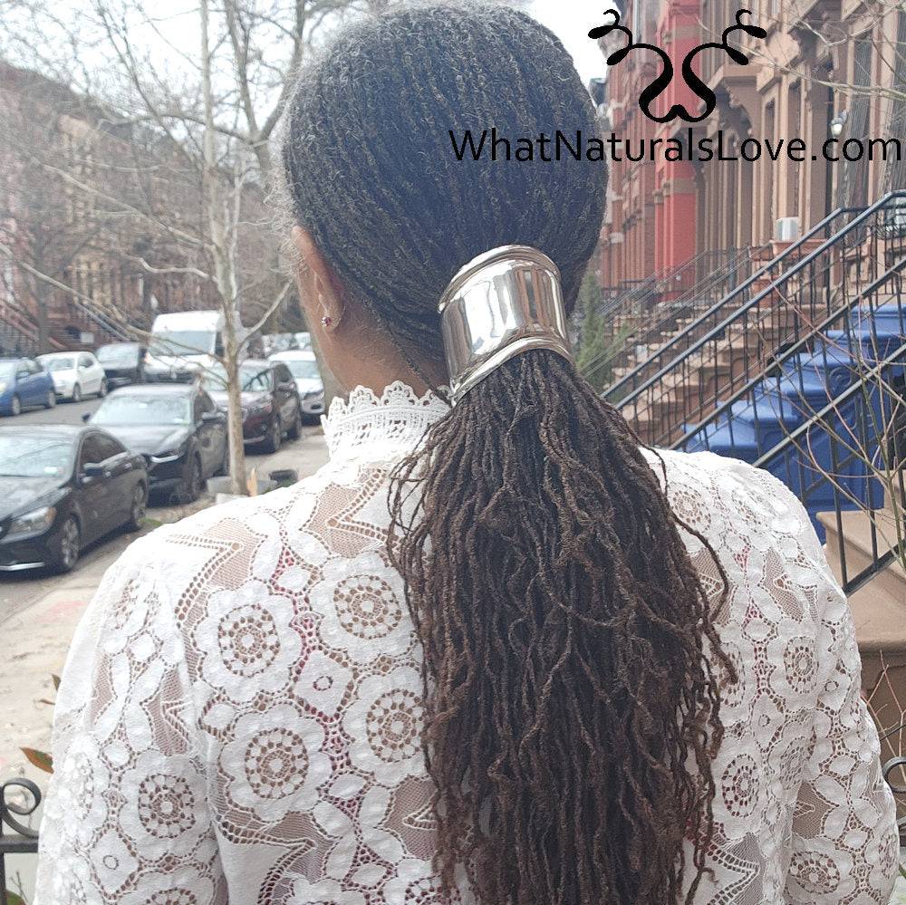 Gold asymmetrical hair cuff bracelet securing locs in a ponytail. Stylish, non-damaging hair accessory for dreadlocks and Sisterlocks.