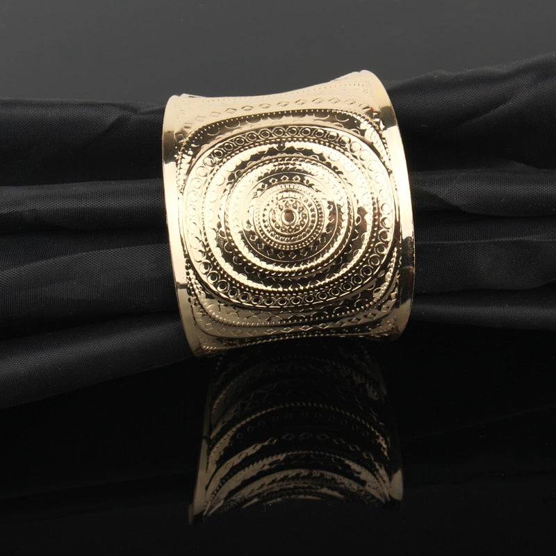 Gold-tone engraved hair cuff with intricate circular patterns for locs, sisterlocks, dreadlocks, and braids. Adjustable and non-damaging hair accessory.