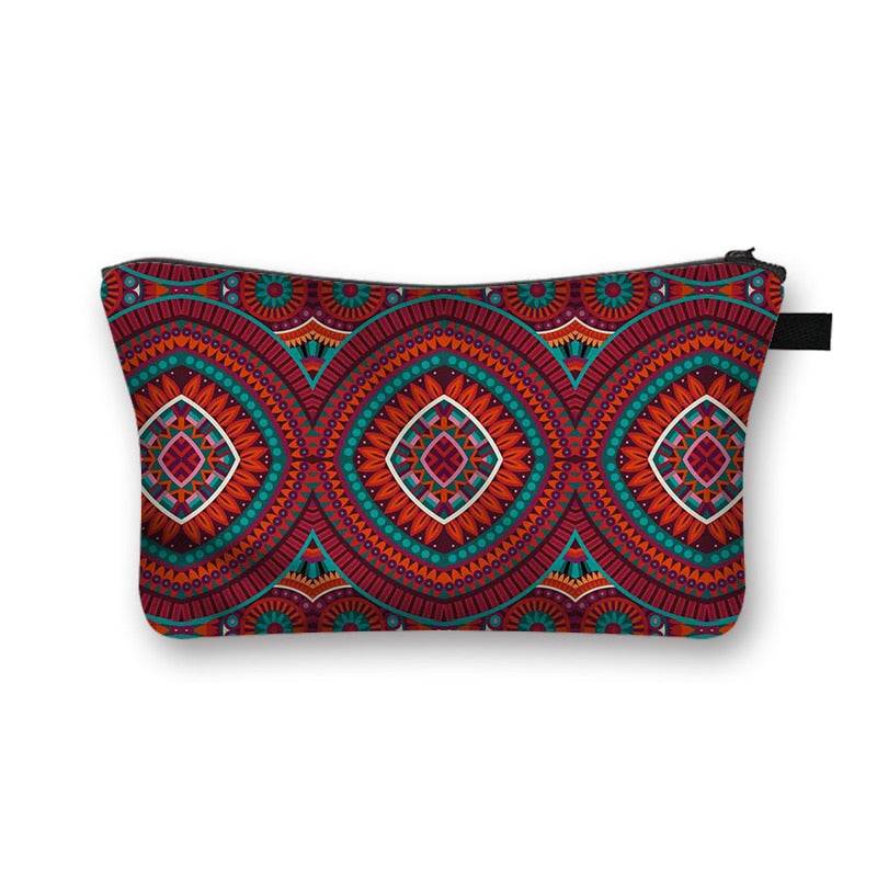 African print makeup bag with red and blue circular tribal patterns. Stylish and lined cosmetic pouch for beauty essentials.