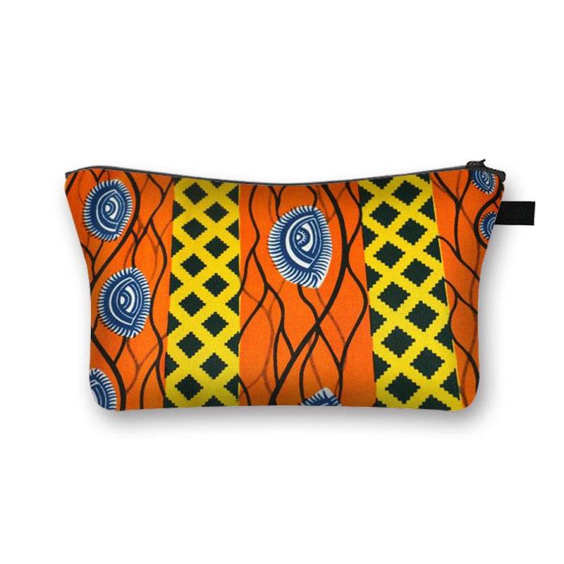 Bright orange African print makeup bag with blue and yellow tribal patterns. Stylish and lined cosmetic pouch for beauty essentials.
