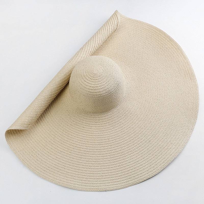Beige oversized 27-inch wide brim sun hat, foldable and ideal for travel and sun protection.