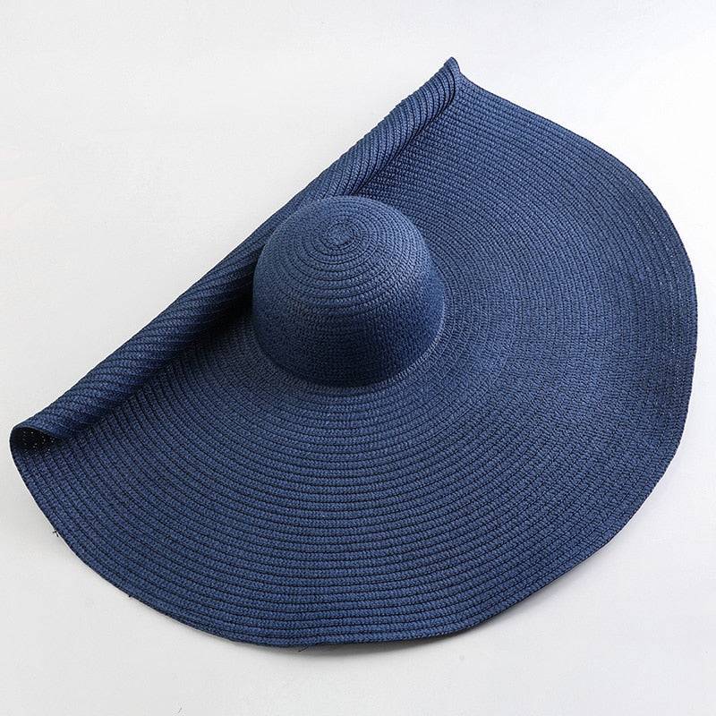 Deep navy blue oversized 27-inch wide brim sun hat, a chic and protective summer accessory.