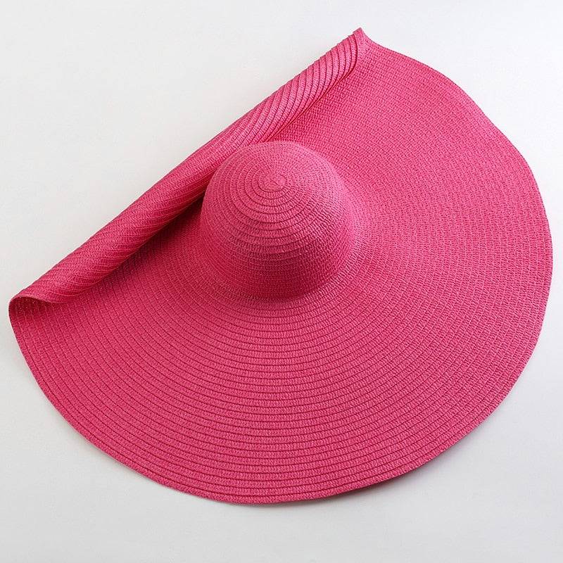 Bright pink oversized 27-inch wide brim sun hat, a fashionable and protective summer essential.