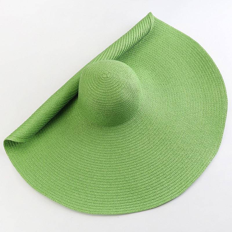 Lush green oversized 27-inch wide brim sun hat, ideal for outdoor summer adventures.
