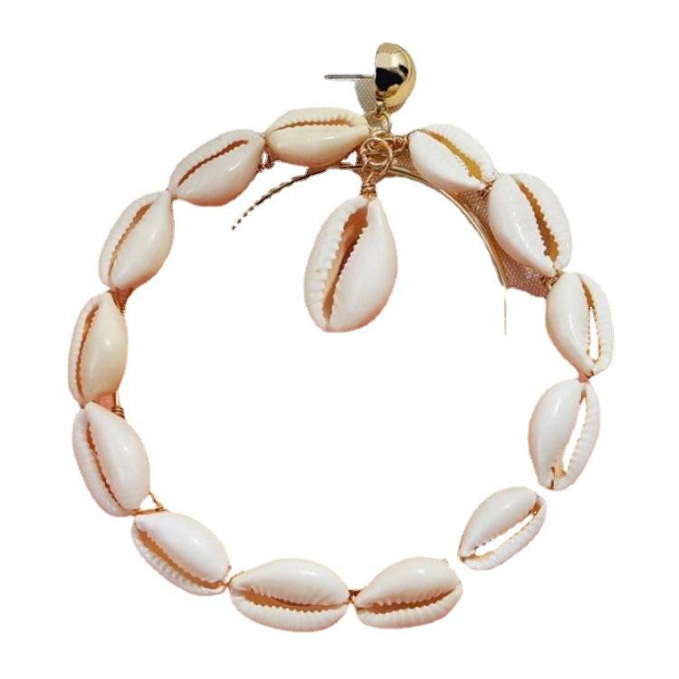 Single double hoop Cowrie Shell earring featuring natural shells and gold-tone metal, designed for a bold and stylish look.