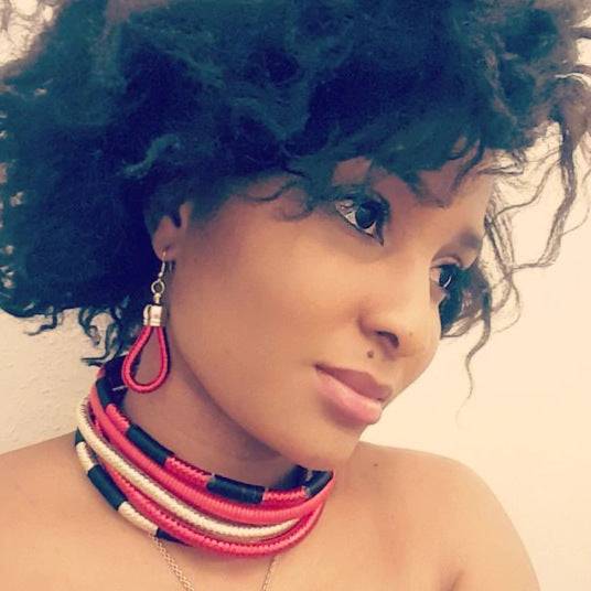 Handcrafted African choker multi-layer necklace set in red, black, and gold with matching earrings. A unique ethnic jewelry piece for any occasion.