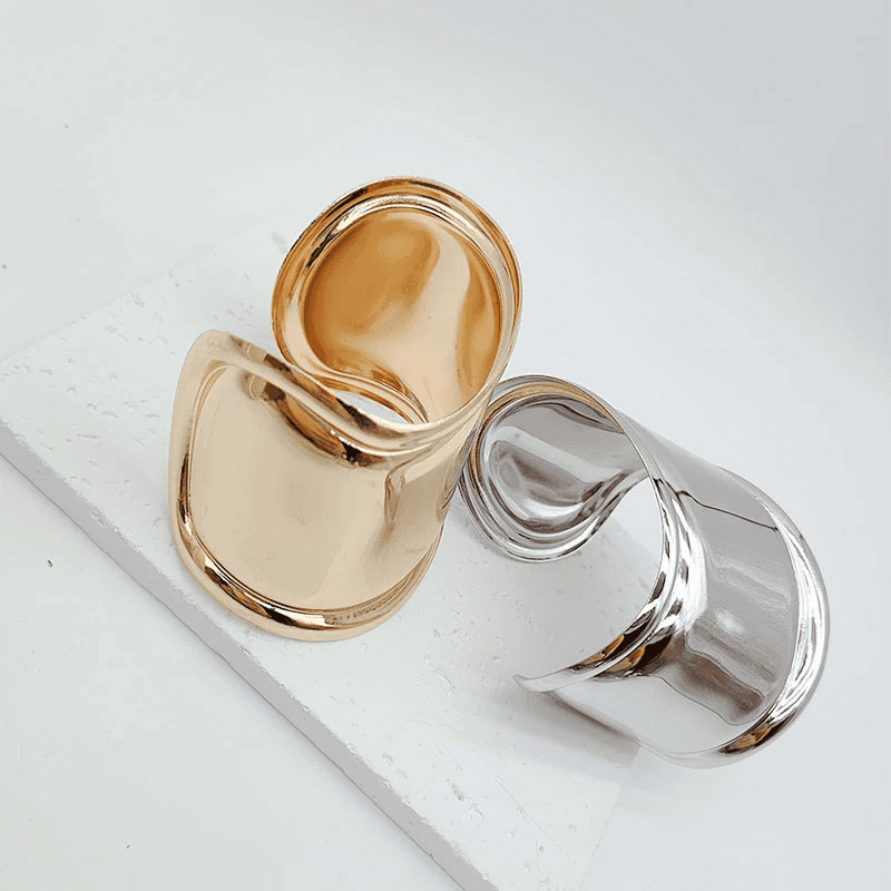 Gold and silver asymmetrical hair cuff bracelets displayed on a white surface. Elegant hair accessories for locs, dreadlocks, and Sisterlocks.