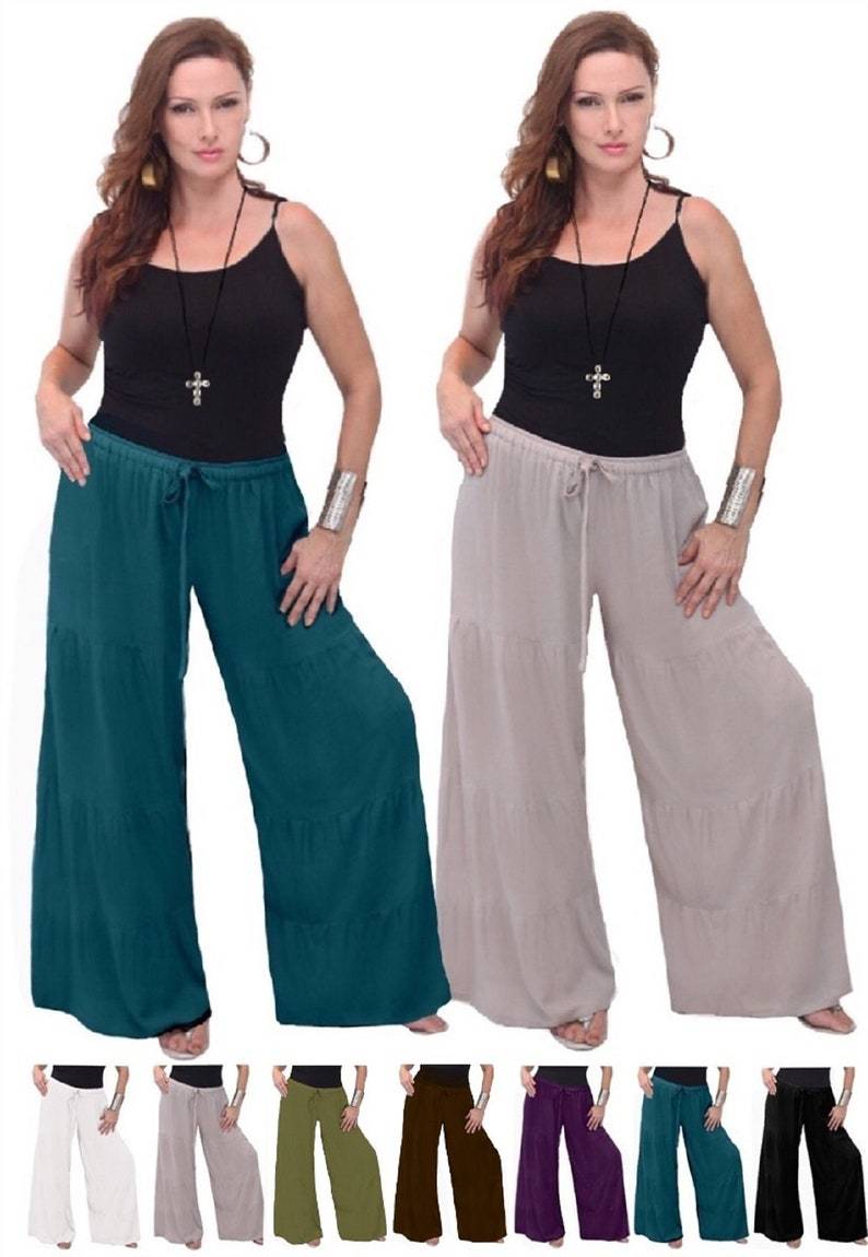 Wide-leg long pants with ruffled tiers and an elastic waist, available in various colors. Perfect for casual and bohemian fashion styles.