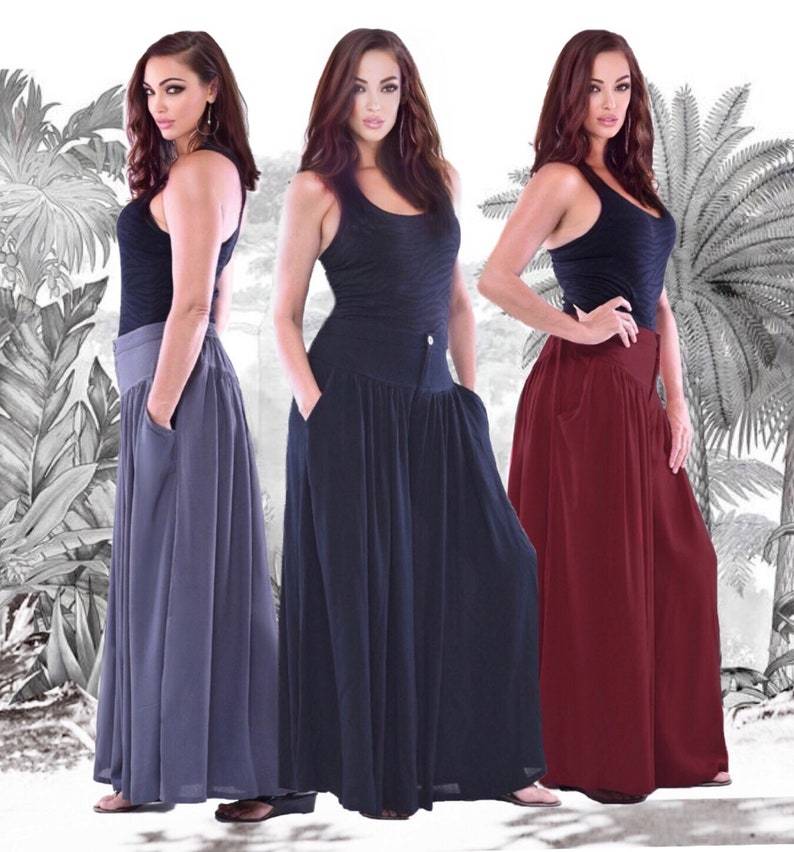 Flowy split skirt palazzo pants with pockets, elastic back, and wide-leg fit. Available in various colors for a chic and versatile look.