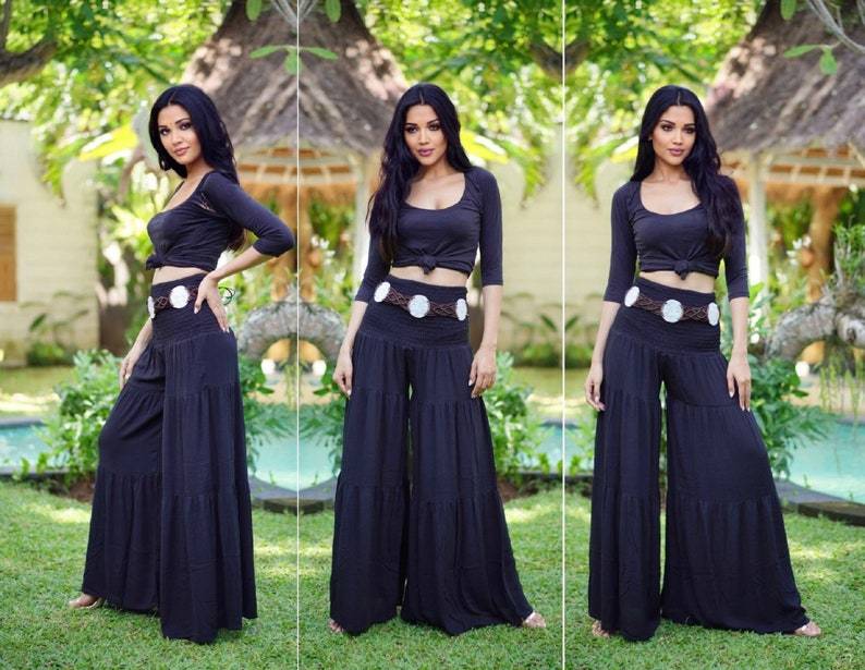 Black ruffled palazzo pants with a smocked waist, styled with a cropped top and belt, perfect for all sizes from S to 5X.