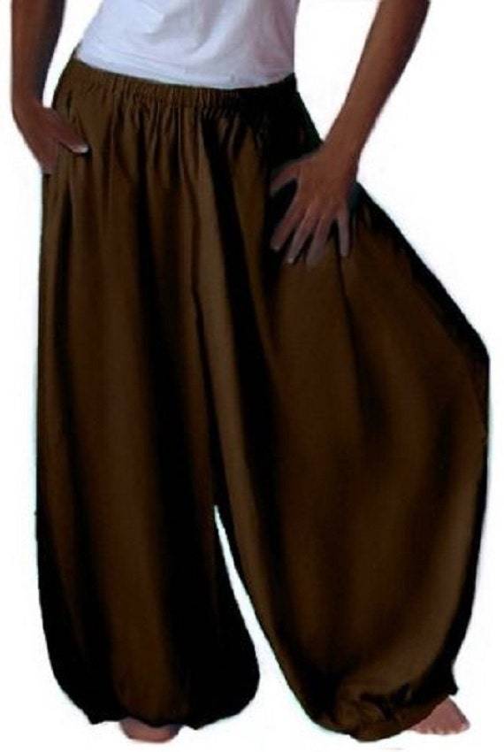 Brown overall harem hippy pants with wide leg gaucho, plus size. Loose-fitting and flowy bohemian-style pants with an elastic waistband and pockets.
