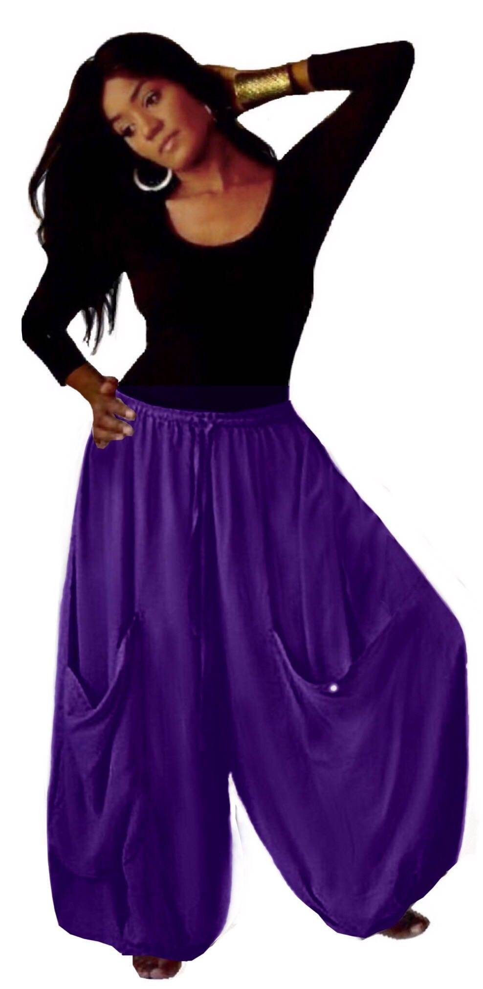Purple wide-leg gauchos pants with an elastic waist, drawstring, and big pockets, offering a stylish and comfortable fit for women.