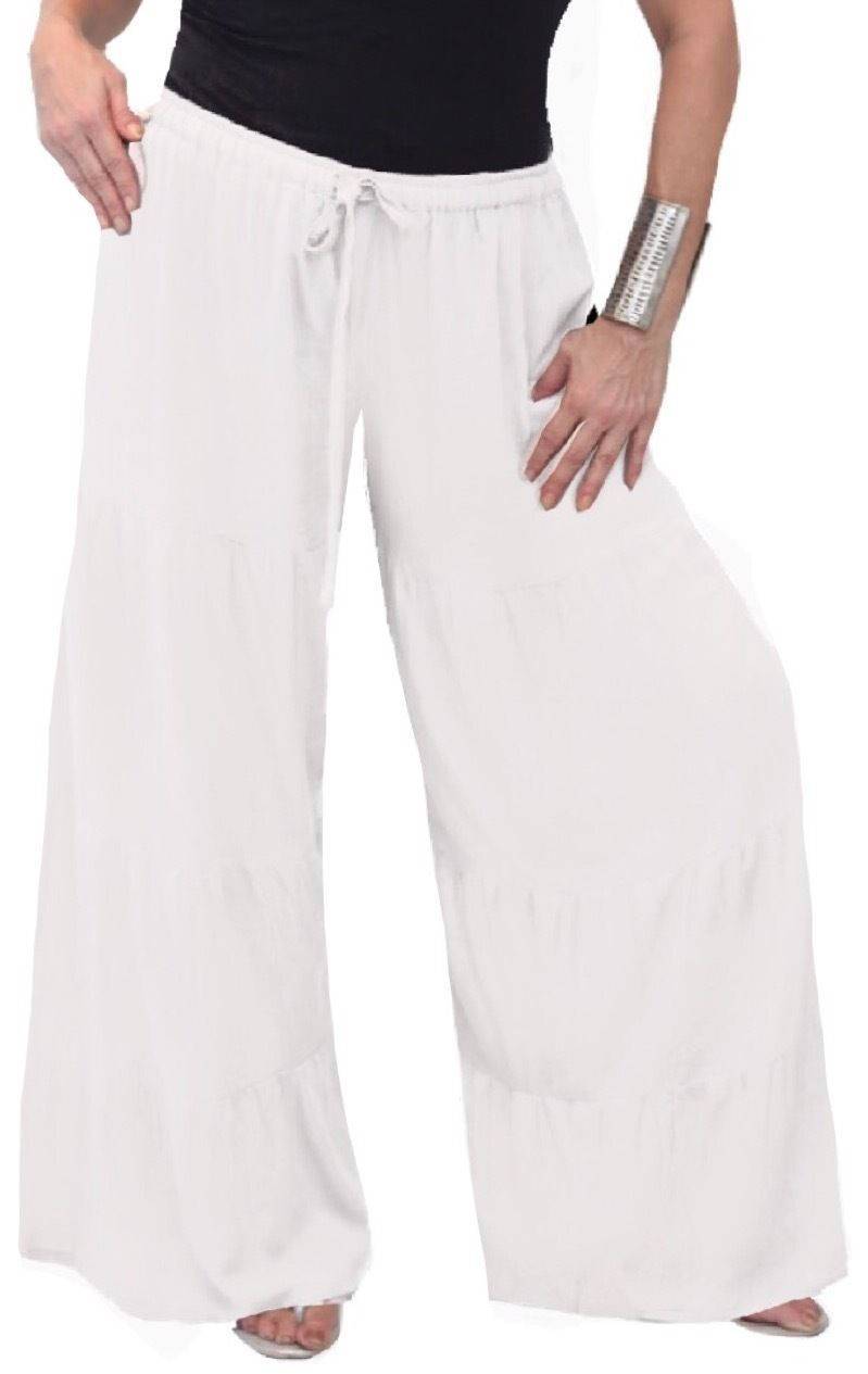 White feminine wide-leg pants with ruffled tiers and an elastic waist. Lightweight and stylish for a relaxed look.