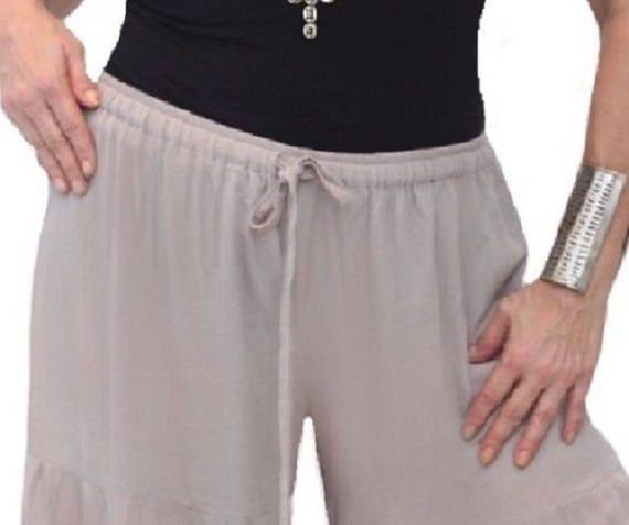 Close-up of beige wide-leg pants with an elastic waist and drawstring. Soft and breathable fabric for ultimate comfort.