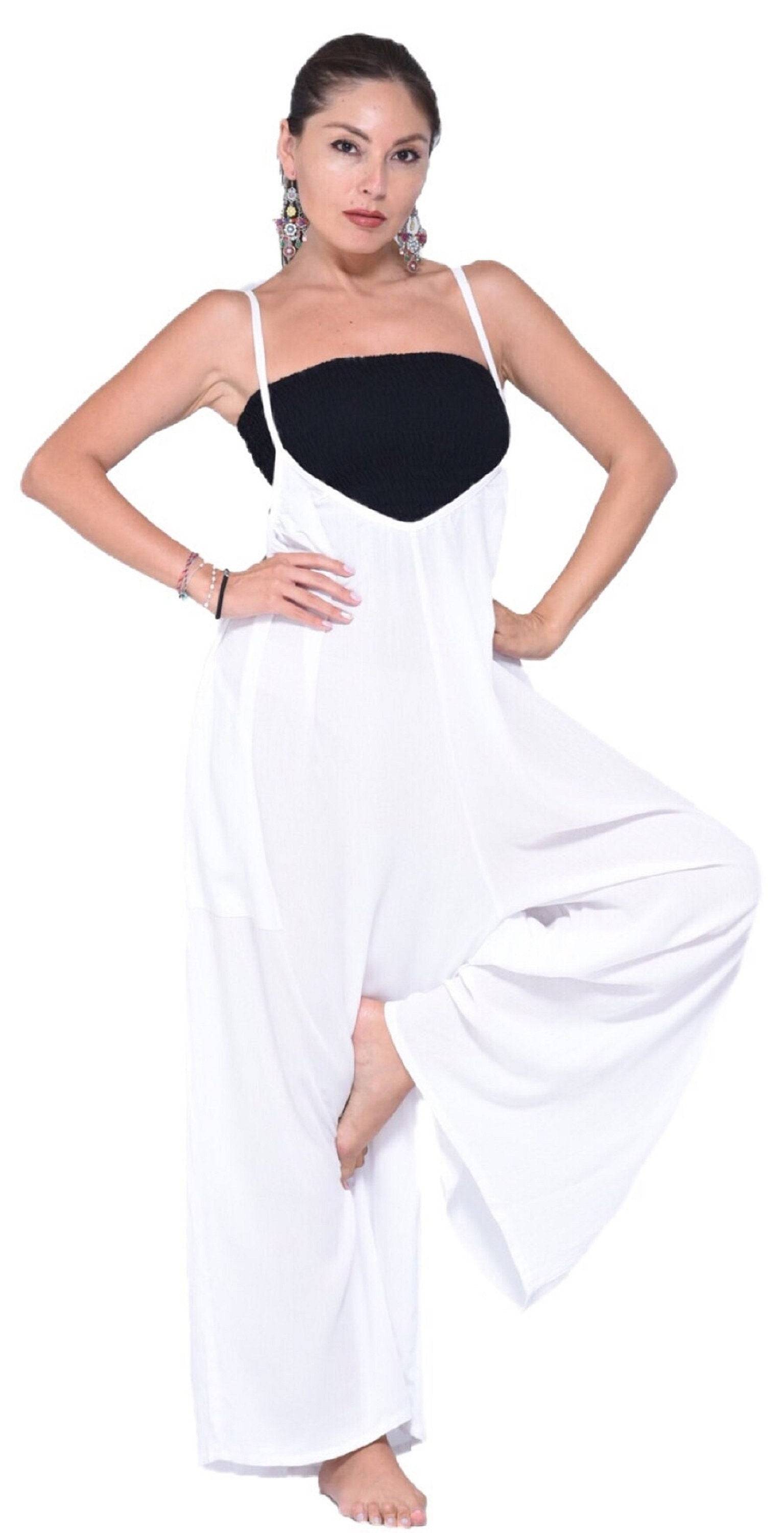 Stylish white jumpsuit with thin straps, wide-leg cut, and pockets. Ideal for casual and chic outfits.