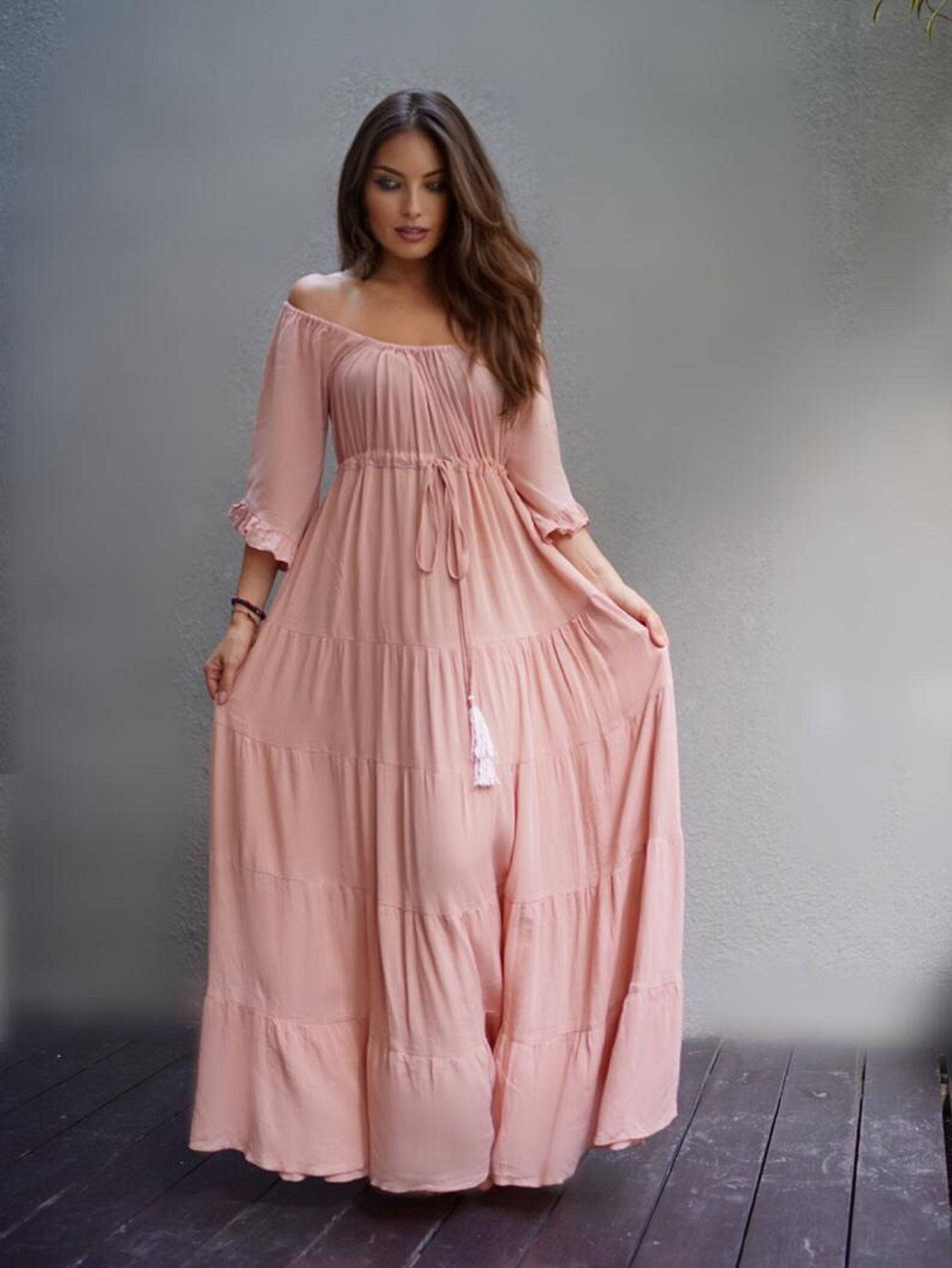 Soft peach maxi dress with sleeves, designed with a tiered skirt and empire bust. A stylish and comfortable choice for boho and plus-size fashion.