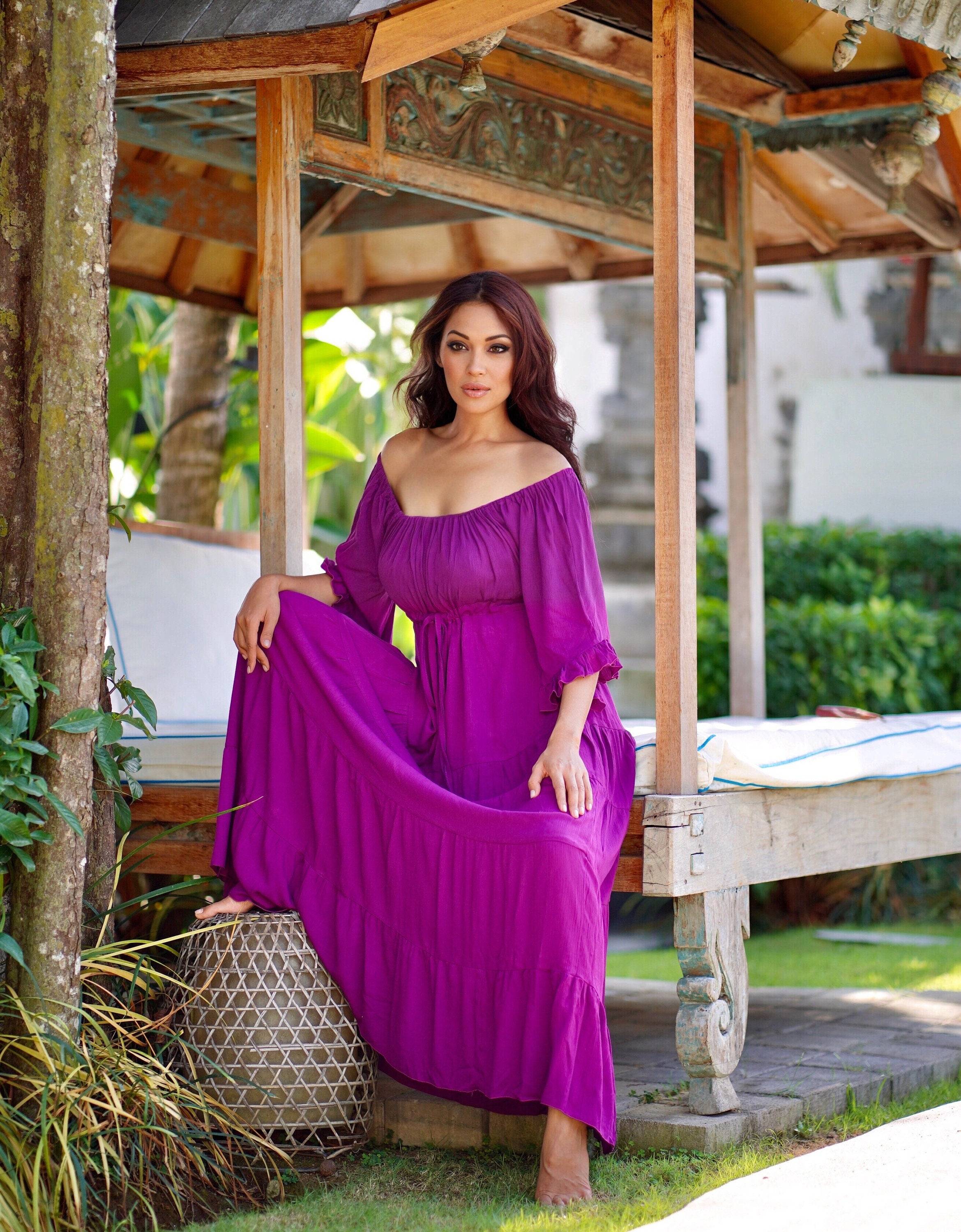 Vibrant purple maxi dress with sleeves, designed with an empire bust and tiered skirt. A stylish and comfortable choice for boho and Viking renaissance fashion.