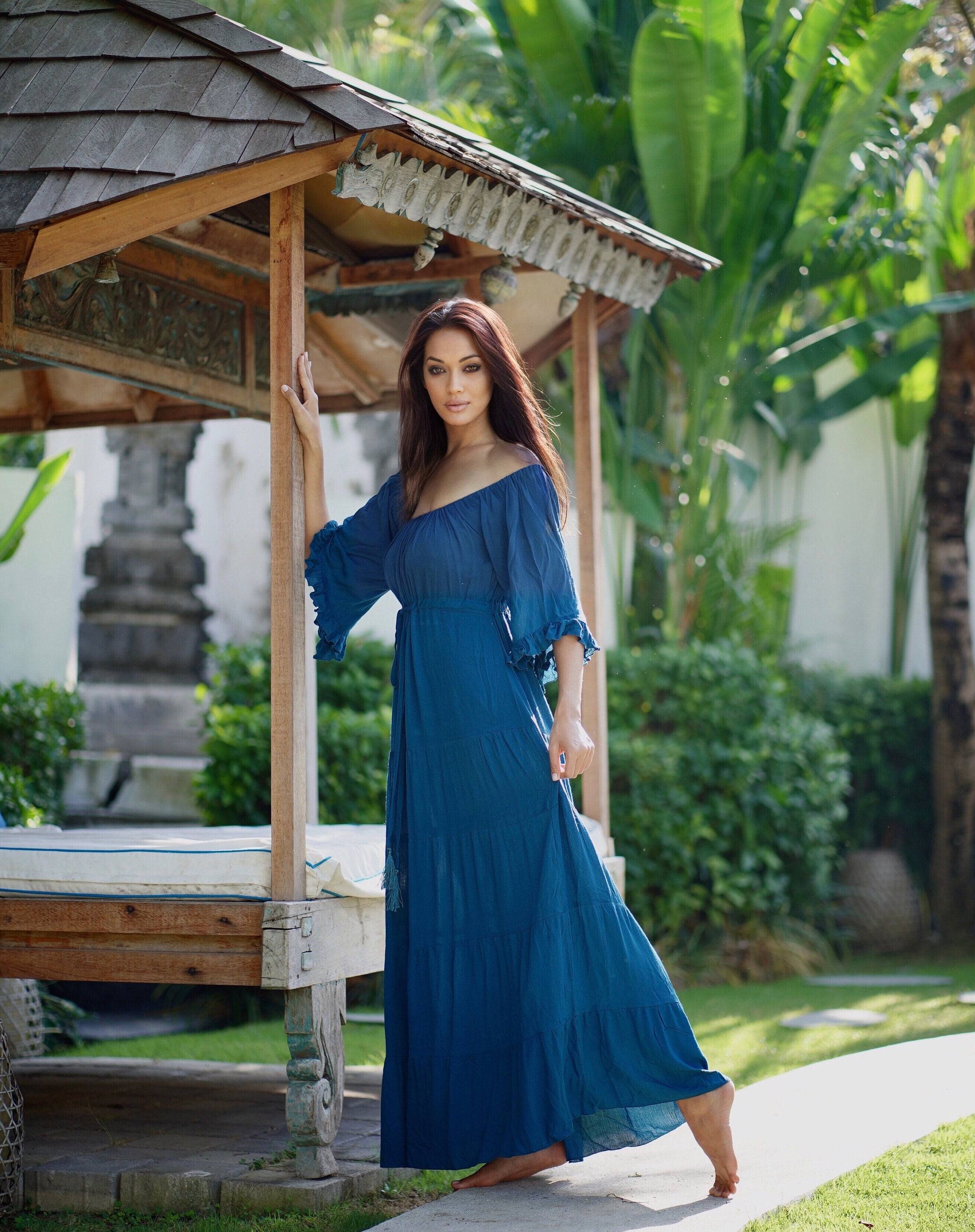 Deep blue maxi dress with sleeves, featuring an off-shoulder design and flowing silhouette. Perfect for boho, Wiccan, and Viking renaissance styles.