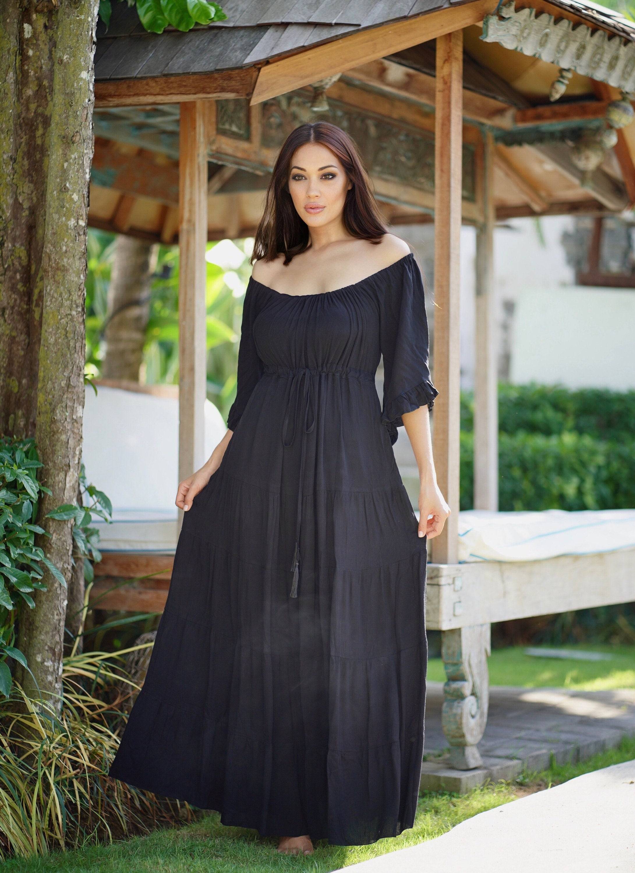 Classic black maxi dress with sleeves, styled with an empire bust and tiered skirt. A timeless choice for boho, plus-size, and Wiccan fashion lovers.
