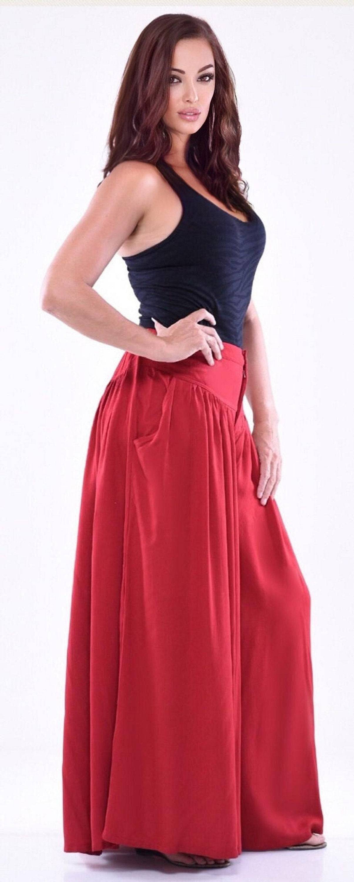 Side view of red split skirt palazzo pants with pockets, elastic back, and wide-leg fit. A stylish and comfortable wardrobe essential.
