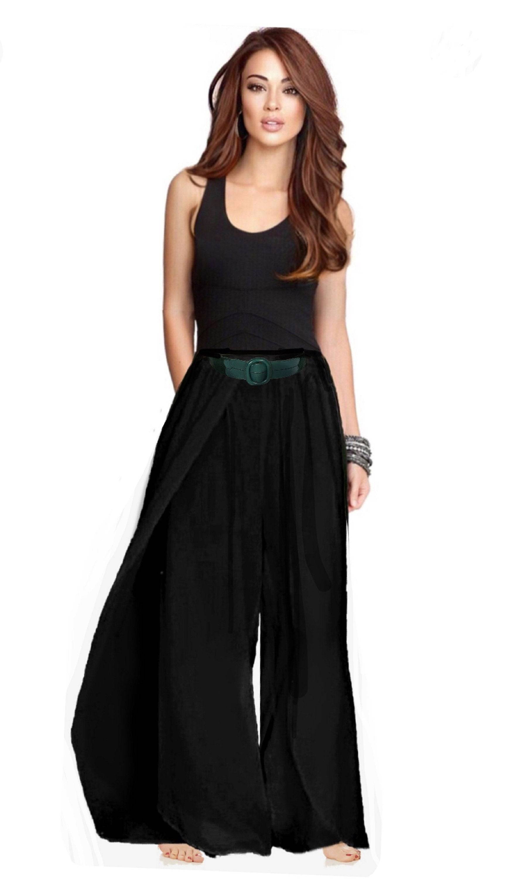 Black full-length layered pants with an elastic waist, styled with a green belt for a chic and comfortable look.