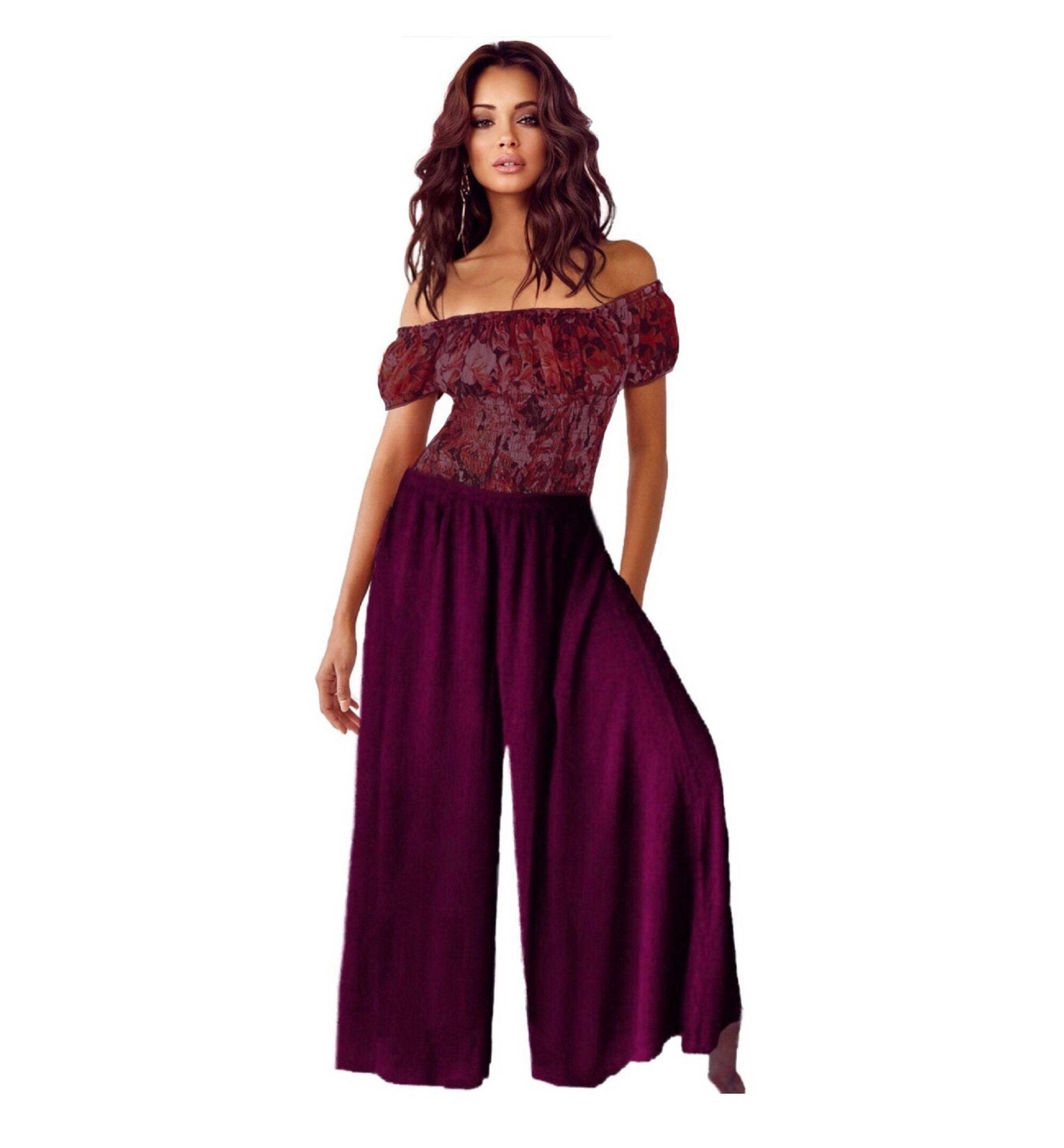 Burgundy split skirt gaucho palazzo pants with a wide leg and elastic waist, paired with a red off-shoulder top for an elegant look.