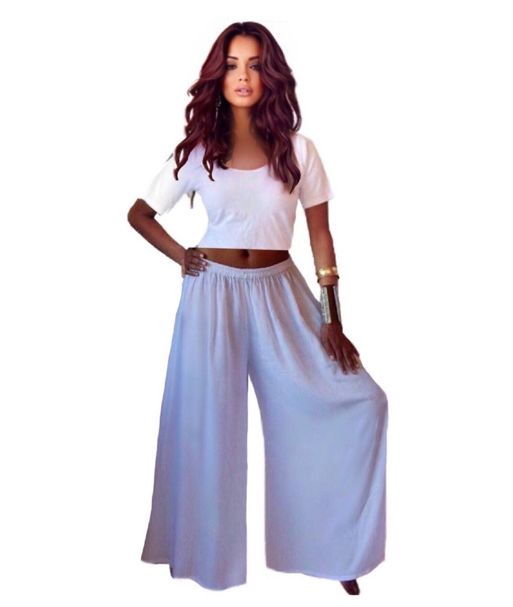 White split skirt gaucho palazzo pants with a wide-leg silhouette and elastic waistband, styled with a white crop top.