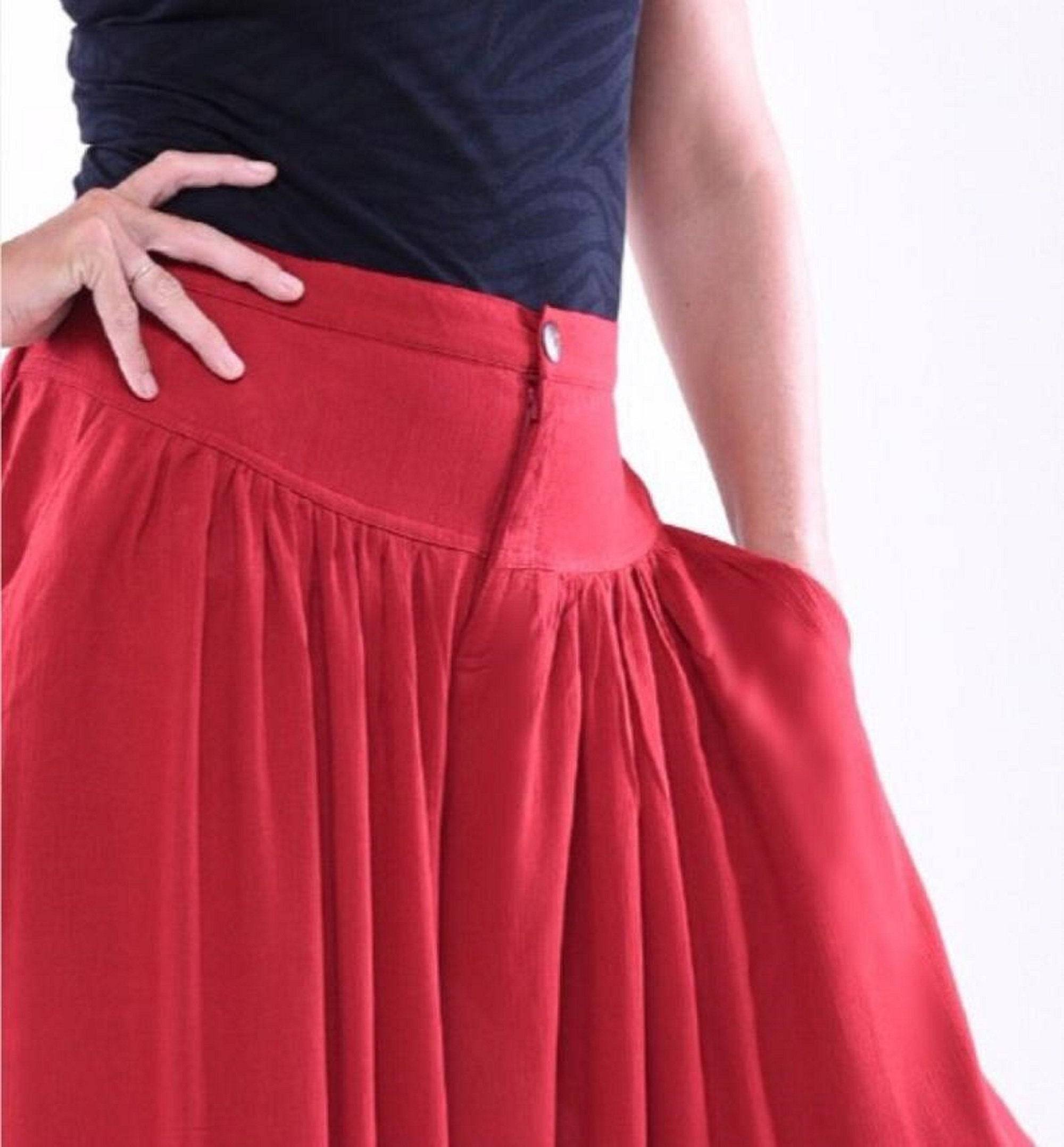 Close-up of red split skirt palazzo pants showcasing the waistband, button detail, and pocket design. Elegant and functional fashion piece.