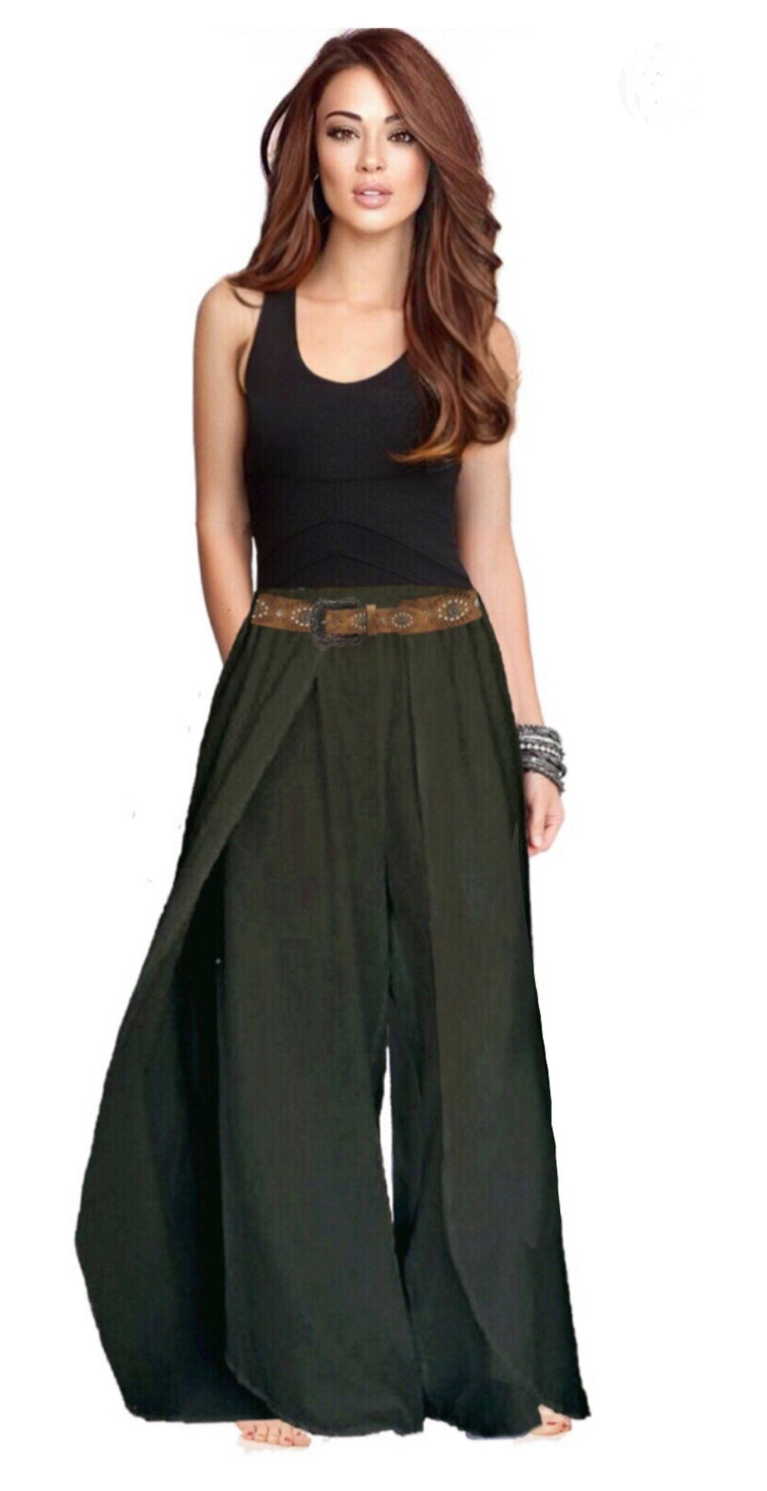 Model wearing stylish dark green rayon pants with an elastic waist and layered faux wrap, perfect for casual or bohemian looks.