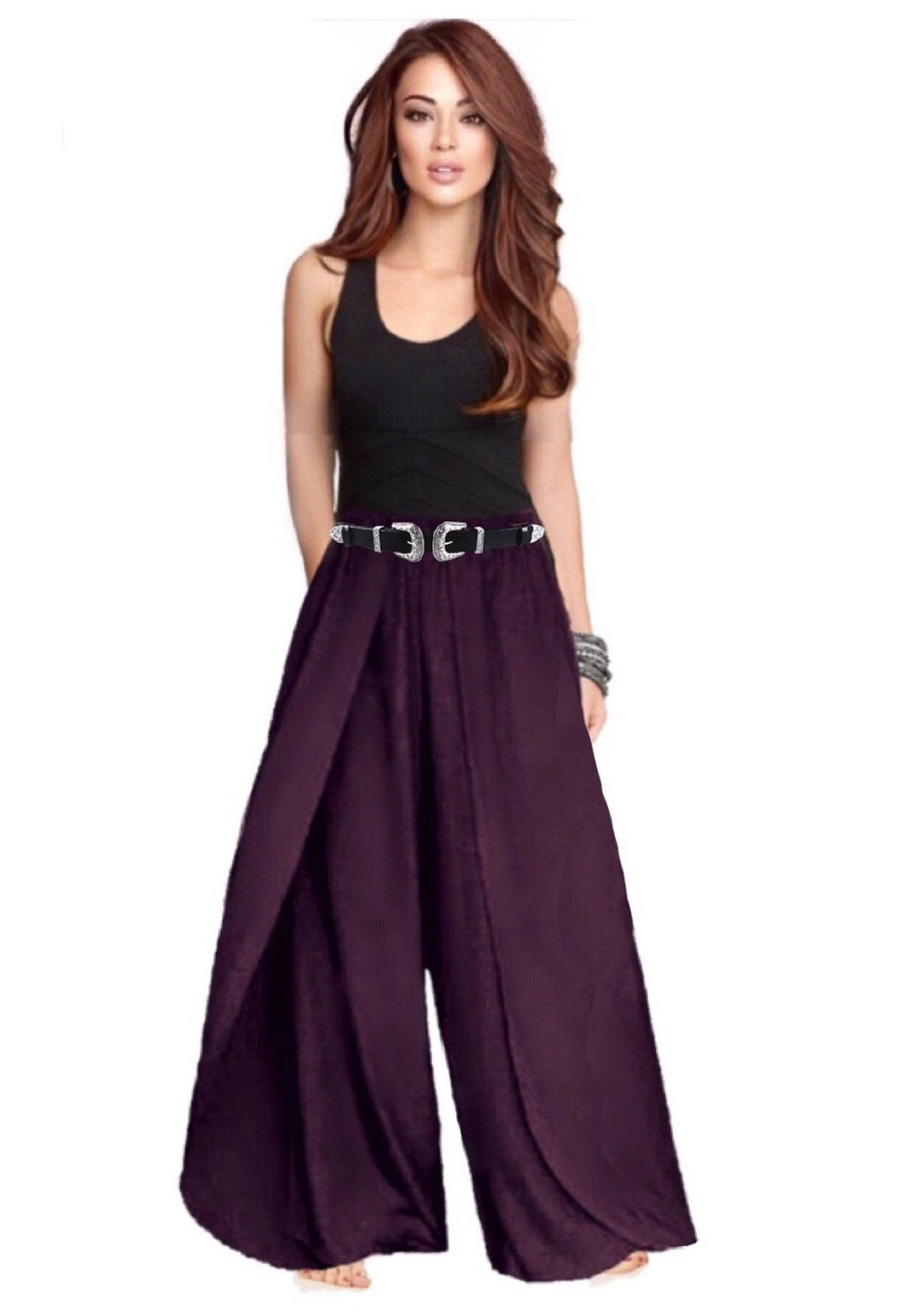 Purple faux wrap layered pants with an elastic waist, paired with a black tank top and a silver belt. Loose and stylish design.