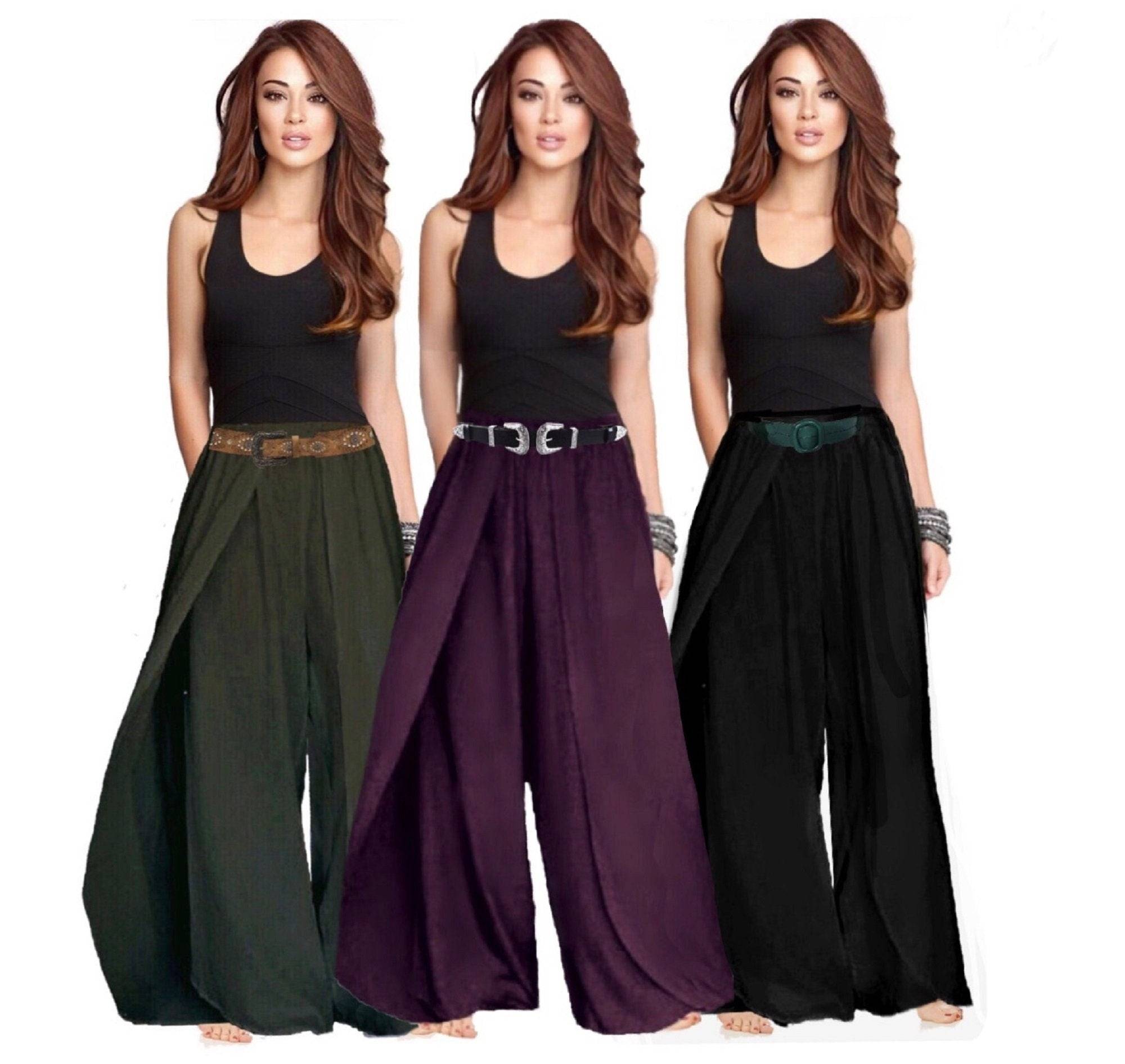 Faux wrap layered pants with an elastic waist in green, purple, and black, styled with a black tank top and belts. Flowy and comfortable design.